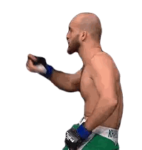 Man in Green Shorts and Boxing Gloves Raising Hand