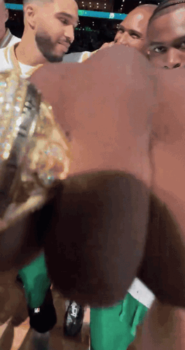Man In Green Shorts Next To Man In Gold GIF