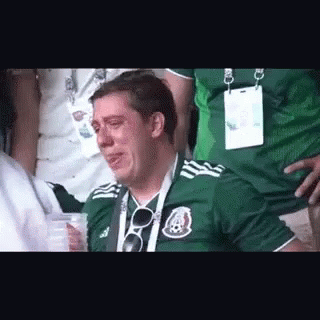 Man in Green Soccer Jersey Crying in Stands