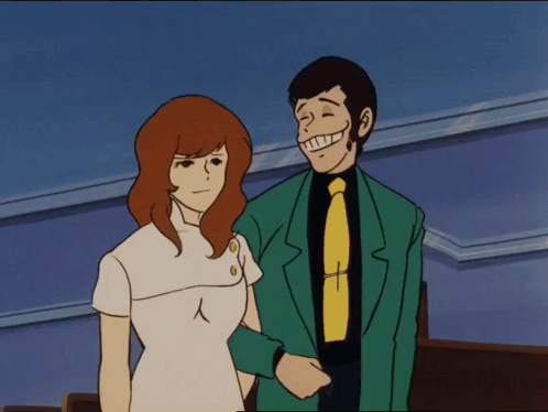 Man In Green Suit Next To Woman GIF