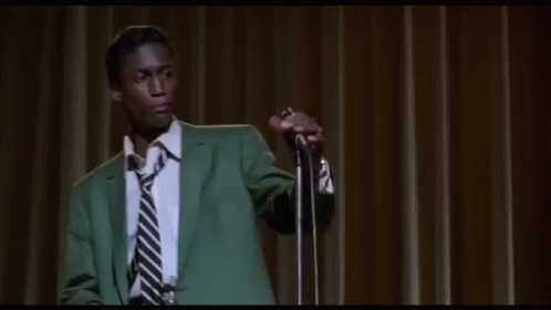 Man In Green Suit Singing Into Microphone GIF