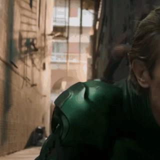 Man in Green Suit Standing in Alleyway