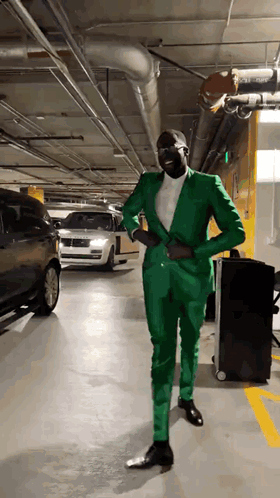 Man in Green Suit Standing in Garage