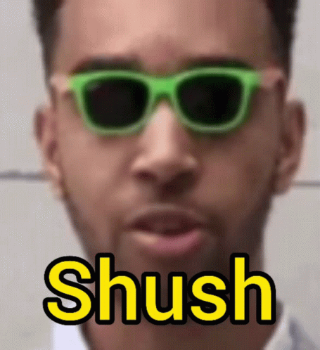 Man in Green Sunglasses Saying Shush in Yellow