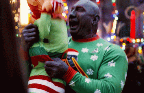 Man In Green Sweater Holding Stuffed Animal GIF