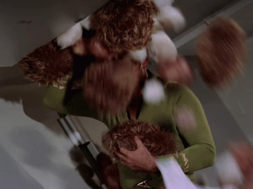Man in Green Sweater Holding Stuffed Animal