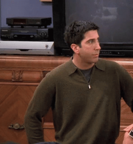 Man in Green Sweater in Front of Pioneer Video Player
