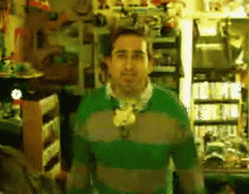 Man in Green Sweater in Store