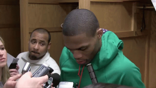Man in Green Sweatshirt Interviewed by Group