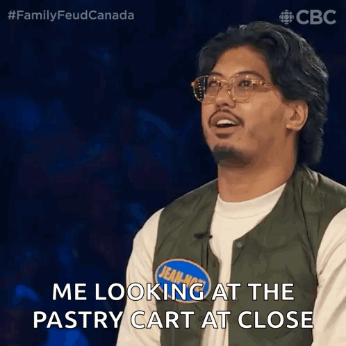 Man in Green Vest Looking at Pastry Cart