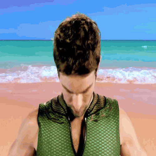 Man In Green Vest On Beach GIF
