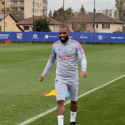Man In Grey Emirates Jersey On Soccer Field GIF