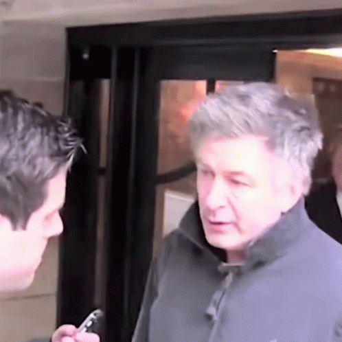 Man in Grey Jacket Talking to Man in Black Jacket
