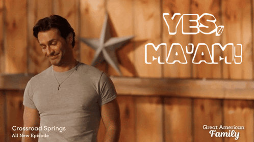 Man in Grey Shirt in Front of Yes Ma'am Wall