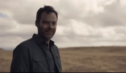 Man in Grey Shirt Standing in Field