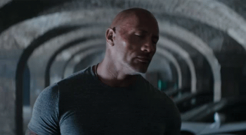 Man in Grey Shirt Standing in Tunnel