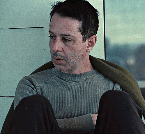 Man In Grey Sweater And Black Pants Sitting GIF