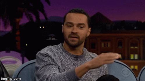 Man in Grey Sweater on Blue Couch Talking