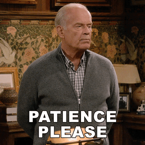 Man In Grey Sweater Saying Patience Please GIF