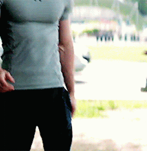 Man in Grey T-Shirt and Black Pants Standing in Park