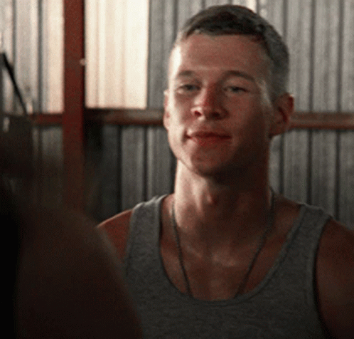 Man in Grey Tank Top Looks at Another