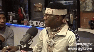 Man in Gucci Headband Sitting at Microphone