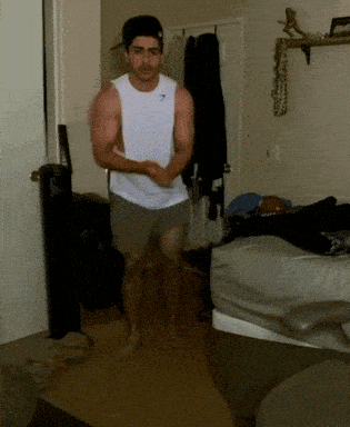 Man In Gymshark Tank Top Running In Room GIF