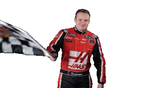 Man in Haas Uniform Holding Checkered Flag