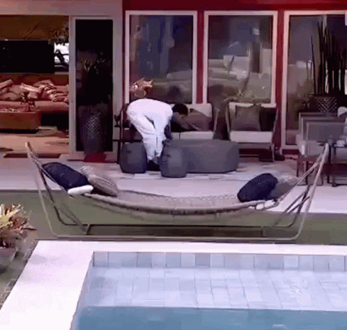 Man in Hammock by Pool