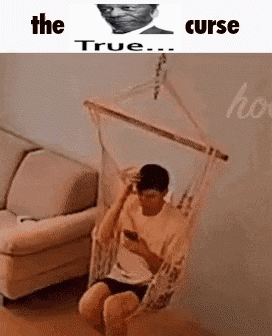 Man in Hammock in Living Room on Phone