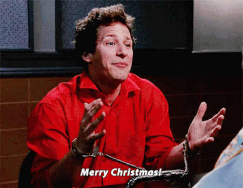 Man in Handcuffs Says Merry Christmas in Red Shirt