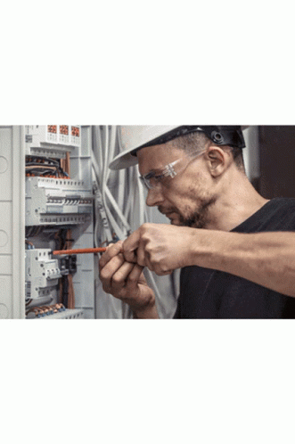 Man In Hard Hat And Safety Glasses Working On Circuit Board GIF