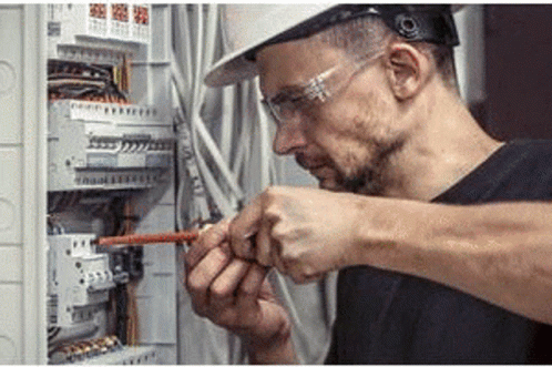 Man in Hard Hat and Safety Glasses Working on Electric Box