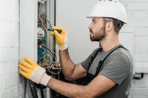 Man In Hard Hat And Yellow Gloves Working On Electrical Box GIF