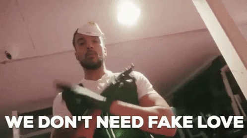 Man in Hard Hat Holding Gun Says We Don't Need Fake Love