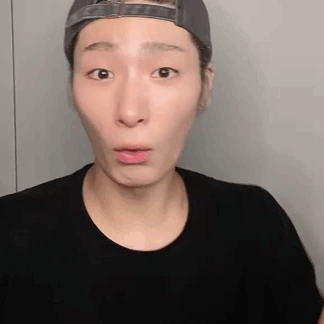 Man in Hat and Black Shirt Making Funny Face