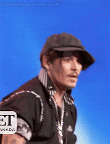 Man in Hat and Black Shirt Saying Et