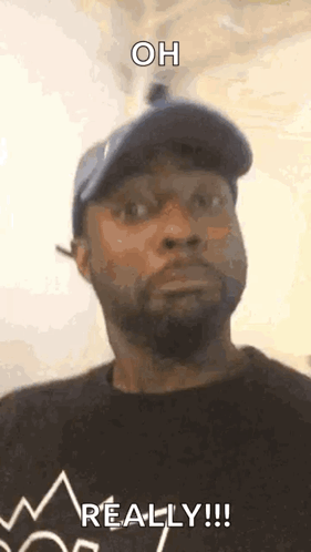 Man In Hat And Black Shirt Saying Oh Really GIF