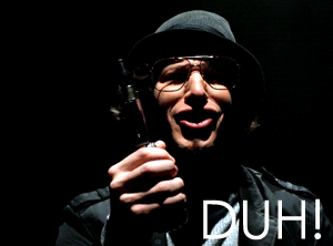 Man in Hat and Glasses Holding Gun With Duh