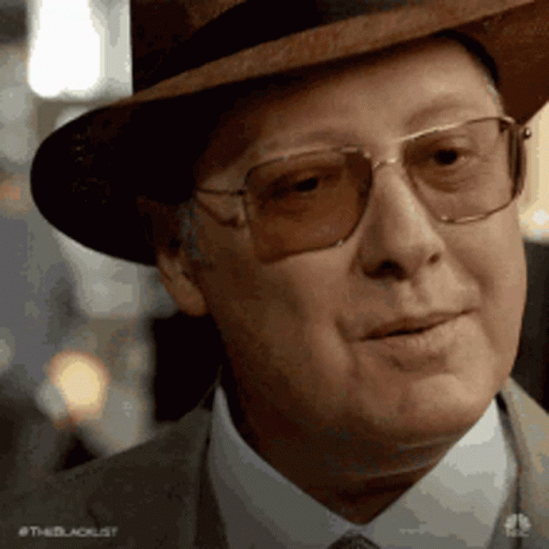 Man in Hat and Glasses Smiling at Camera