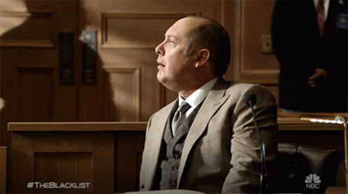 Man In Hat And Glasses Talks To Woman #Theblacklist GIF