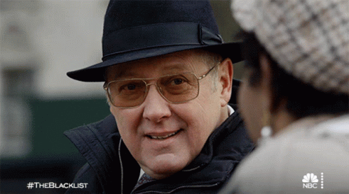 Man In Hat And Glasses Talks To Woman #Theblacklist GIF