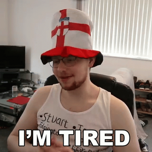 Man in Hat and Glasses With I'm Tired Shirt