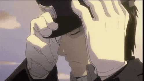 Man in Hat and Gloves Crying Holding Head