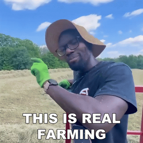 Man in Hat and Green Gloves Farming