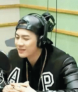 Man in Hat and Headphones at Microphone
