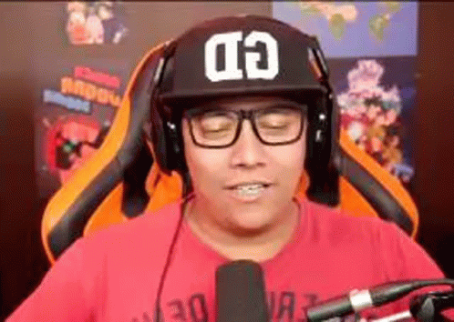 Man In Hat And Headphones Sitting At Microphone GIF