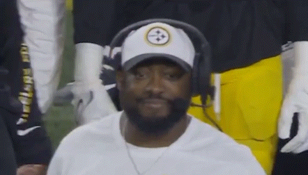 Man in Hat and Headphones Sitting in Stands