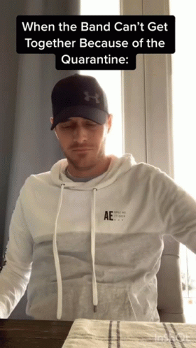 Man in Hat and Hoodie Saying AE