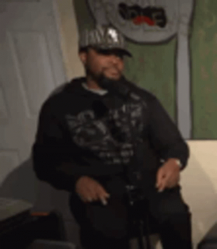 Man in Hat and Hoodie Singing
